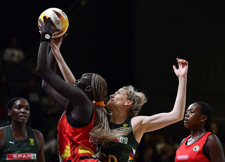 Karla Pretorius of South Africa attempts to block Mary Cholhok of Uganda in their 2023 Netball World Cup fifth/sixth place match at Cape Town International Convention Centre, Court 1 on August 6 2023.