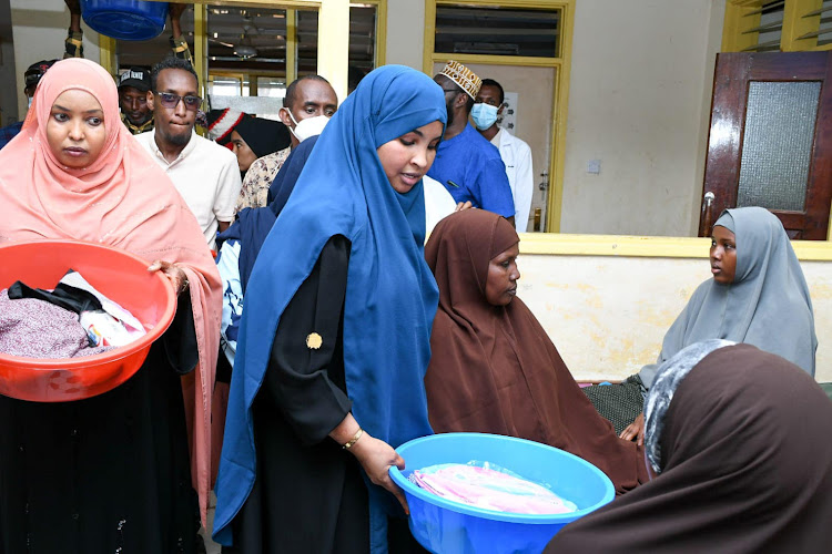 Garissa woman representative Udgoon Siyad having a word with a fistula patient at the Garissa County referral hospital.