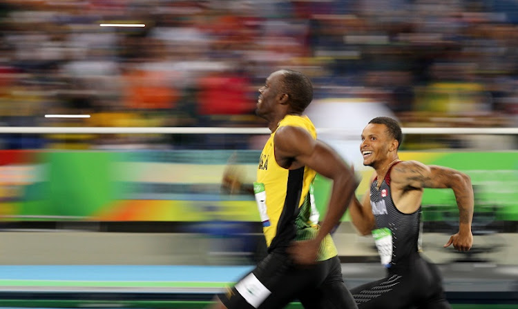 2016 Rio Olympics - Athletics - Semifinal - Men's 200m Semifinals - Olympic Stadium - Rio de Janeiro, Brazil, August 17, 2016. Usain Bolt (JAM) of Jamaica and Andre De Grasse (CAN) of Canada smile as they compete.