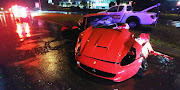 The remains of a Ferrari that hit a lamppost and split into two on William Nicol Drive on Friday.