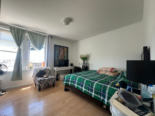 Bedroom with bed, television, and armchair - Prestige property for sale in Union City, 2 bedrooms