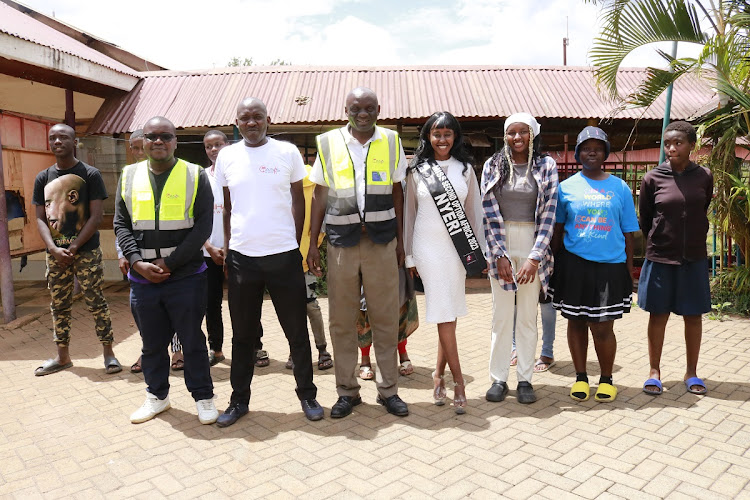 Slum Outreach Programme CBO founder Erick Ambuche(Third from Left), Miss Nyeri County Faith Kasiva and Joyline Mwenda with peers at Mkuru Kwa Njenga in Embakasi South, Nairobi on May 12, 2024.