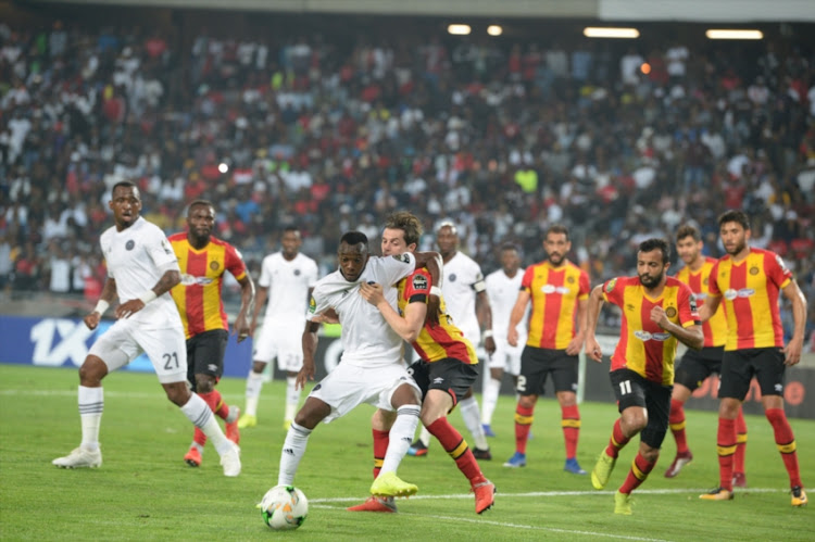 Orlando Pirates player Justin Shonga and Ayman Mohamed of Esperance during the CAF Champions League match between Orlando Pirates and Esperance at Orlando Stadium on February 02, 2019 in Johannesburg, South Africa.