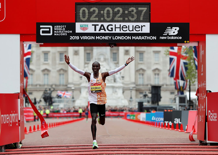 Kenya's Eliud Kipchoge celebrates winning the men's elite race and setting a new course record in London on April 28, 2019.