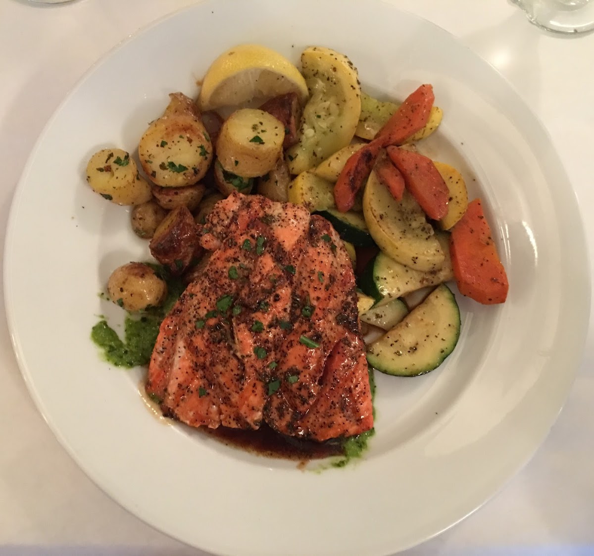 Wild King Salmon with Salsa Verde Sauce, Roasted Potatoes and Sautéed Vegetables.