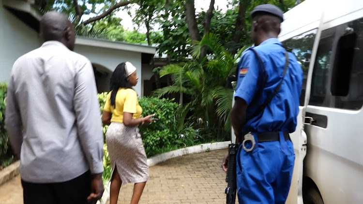 Security personnel escort an official at Malindi resort.