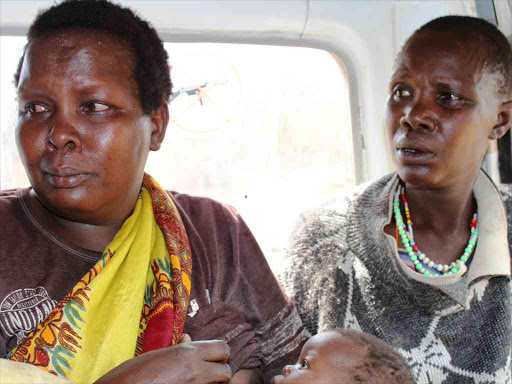 Two women cry as they are evacuated by Red Cross in Chebinyiny, Baringo South following bandits attacks. /JOSEPH KANGOGO