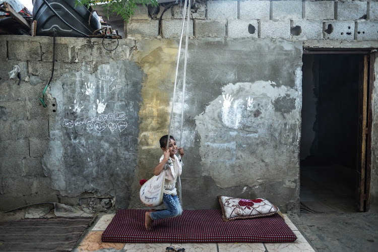 Alaa Al-Manai'a plays in her family's house in a poverty-stricken quarter in the Al-Karamah neighbourhood of Gaza City. More than a billion people worldwide still live on less than $1.25 (R21) a day.