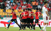 Mohamed Salah celebrates with teammates after scoring the opening goal.