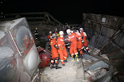 Rescue workers move injured people on the site where a hotel being used for the coronavirus quarantine collapsed,in the southeast Chinese port city of Quanzhou, Fujian province, China, on March 7 2020. 