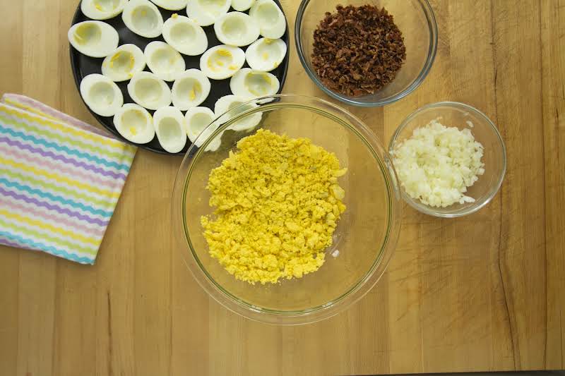 Bowl Of Mashed Egg Yolks With Crushed Bacon And Minced Onion