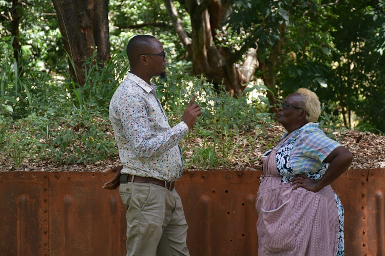 Kiambu County Director Culture and Heritage, Kennedy Mwangi (left) haves a word with Rose Gicharu the caretaker of the Mugo wa Kiburu historical site in Thika