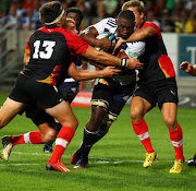 Siyamthanda Kolisi of the Stormers drives for the try line with Dwayne Jenner of the Southern Kings and Michael Killian of the Southern kings during the Super Rugby Warm Up match between Southern Kings and DHL Stormers at Nelson Mandela Bay Stadium on February 07, 2014 in Port Elizabeth, South Africa.