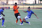 Daylon Claasen of Maritzburg United challenged by Vincent Pule of Orlando Pirates.