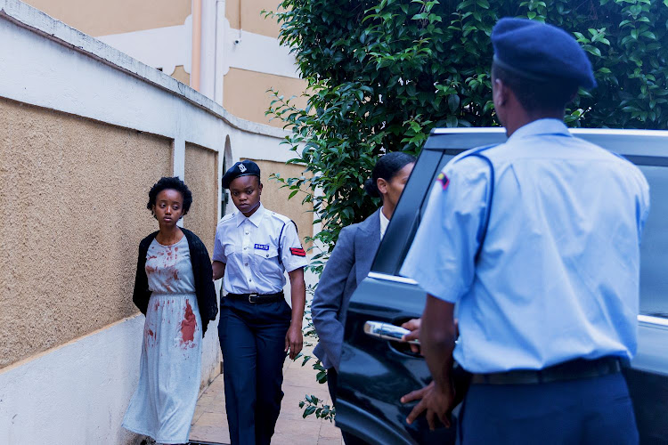 Rehema (Foi Wambui) is led away by the police from the crime scene.