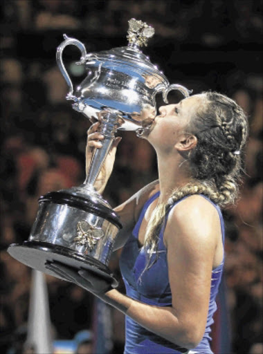 SCREAM QUEEN: Victoria Azarenka kisses her trophy as she celebrates after defeating Maria Sharapova in their singles final match at the Australian Open on Saturday. Photo: REUTERS