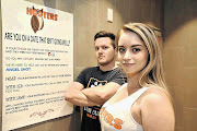 SECRET SOCIETY: Hooters waitress Jade Hammond and barman Matthew Smith point out a sign in the female bathroom giving young women a code word to use to staff or if they need help from the barman if a date is going wrong