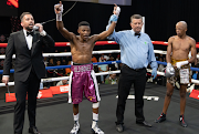 Ring announcer Dev Currer reading out that Mzuvukile Magwaca, with his arms raised, had beaten Sanele Maduna during a bout in Johannesburg in April last year. 