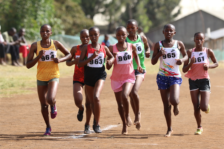 Athletes compete in the girls' under 18 5km race during the Nairobi region cross country championship at Nairobi West Prison grounds