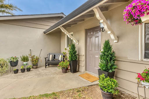House entrance with bench and plants in this luxury house for sale in Salinas ($749,999)