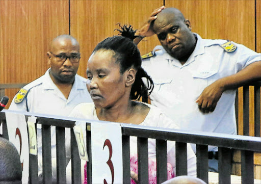 Lebohang Mbola at the Mdantsane magistrate's court. She is facing two counts of murder for allegedly shooting her husband dead and setting his girlfriend alight. Picture: MALIBONGWE DAYIMANI