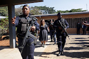  Nongcebo Faith Ntombela is escorted into the Umlazi magistrate's court where she appeared in connection with the death of her husband, Capt Thomas Ntombela.