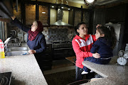 Hadeel Alam speaks with her family after training at home.