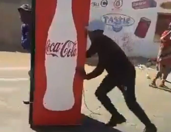 Guys stealing a coke fridge in Zola Soweto.