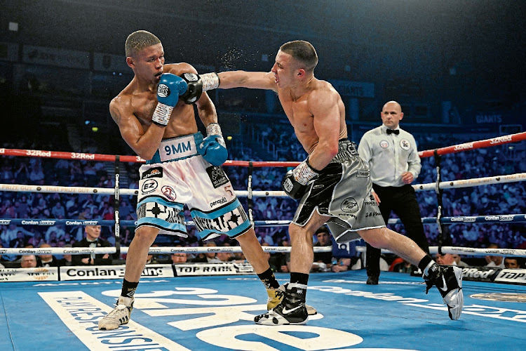 Nick Ball punches Ludumo Lamati during the Featherweight fight at The SSE Arena Belfast on May 27, 2023 in Belfast, Northern Ireland.