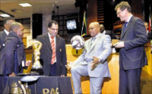 HOW IT'S DONE: President Jacob Zuma demonstrates his skills with a soccer ball given to him by Fifa general secretary Jérôme Valcke, right. Valcke had just handed over the Confederations Cup trophy to Zuma. Circa. 2009. © Unknown.