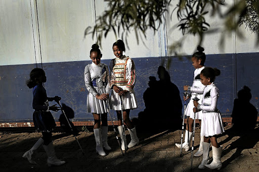 Two leaders in the centre, Runique Lukas and Caslynn De Vos of Bernard Isaacs Primary School Drum Majorettes.