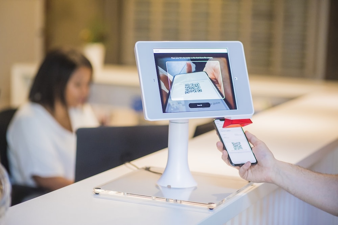 a person scanning the QR code on the system in a hospital