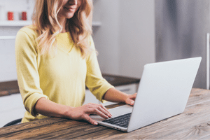 Blonde woman typing on her laptop