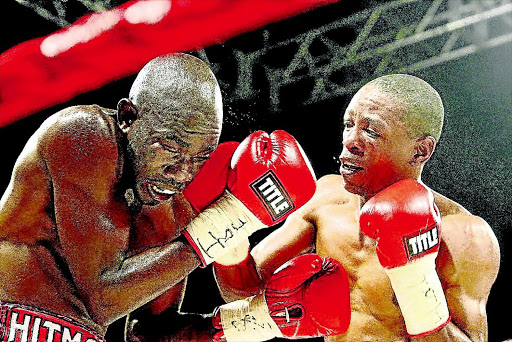 SIMPLE PLAN: Mzonke 'Rose of Khayelitsha' Fana, right, gives Cassius Baloyi a painful punch during their fight at Carnival City in Brakpan PHOTO: Antonio Muchave