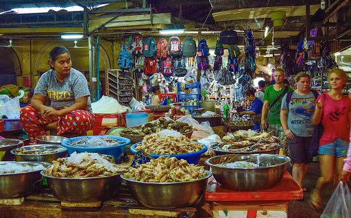 cambodia-shop-employee.jpg - A favorite ‘must see’ site in any city:  Open market in Siem Reap.  US currency happily accepted even for small purchases.