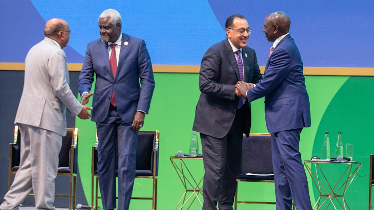 President William Ruto and African Union Commission chairperson Moussa Faki greeting other leaders at the podium during the Africa Climate Summit on September 5, 2023