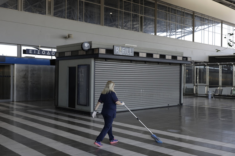 A worker cleans the floor at Thessaloniki Makedonia Airport, operated by Fraport Greece, in Thessaloniki, Greece, on Wednesday, May 19 2021. Picture: BLOOMBERG/KONSTANTINOS TSAKALIDIS