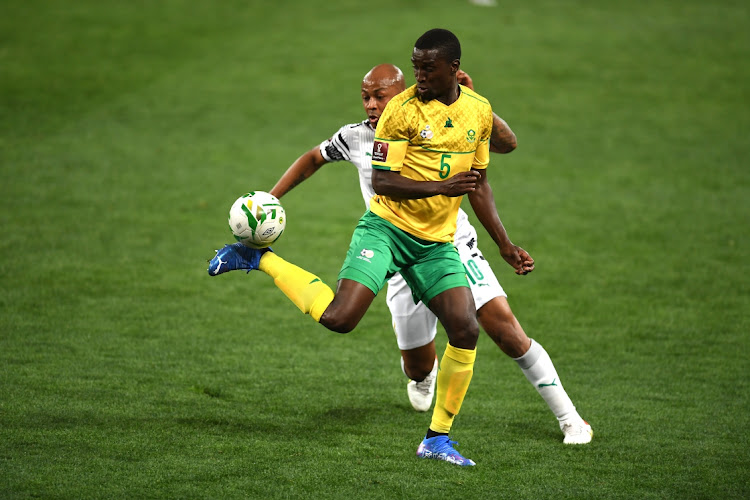 Andre Ayew of Ghana and Siyanda Xulu of South Africa during the 2022 FIFA World Cup Qualifier match between South Africa and Ghana at FNB Stadium.