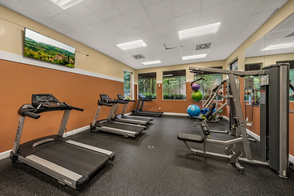 Fitness Center with cardio and cable machines and exercise balls