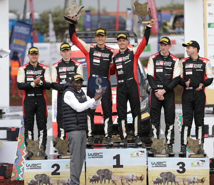 President William Ruto with Toyota Gazoo teams (from L) Scott Martin and Elfyn Evans (3rd Position), Sebastian Ogier and Vincent Landais (1st position) and Kalle Rovanpera and Jonne Hulttunen (2nd Position) celebrate their podium finish of the 2023 WRC Safari Rally in Naivasha. June 25, 2023.