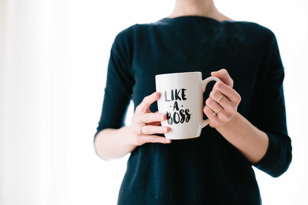 A woman with a “Like a Boss” coffee mug