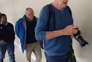 A handcuffed Rob Packham leaves the high court in Cape Town after a brief appearance on September 25 2018.