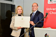 Italian ambassador to SA Paolo Cuculi confers the honour on Professor Cristina Trois.