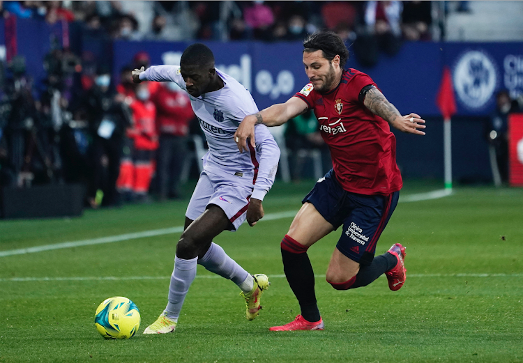 Barcelona's Ousmane Dembele in action with Osasuna's Juan Cruz