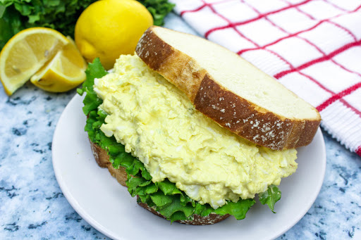 Deluxe Egg Salad Sandwich on white bread with lettuce.