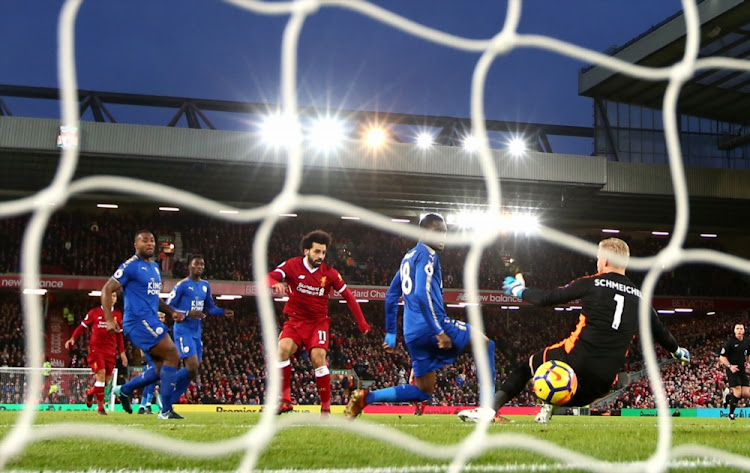 Mohamed Salah of Liverpool scores their first goal past Kasper Schmeichel of Leicester City during the Premier League match between Liverpool and Leicester City at Anfield on December 30, 2017 in Liverpool.