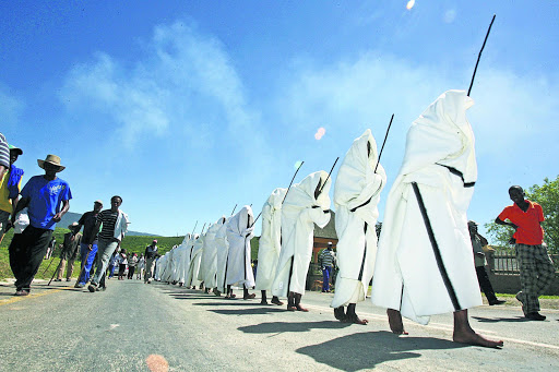 Initiates return dressed in white blankets. File photo.