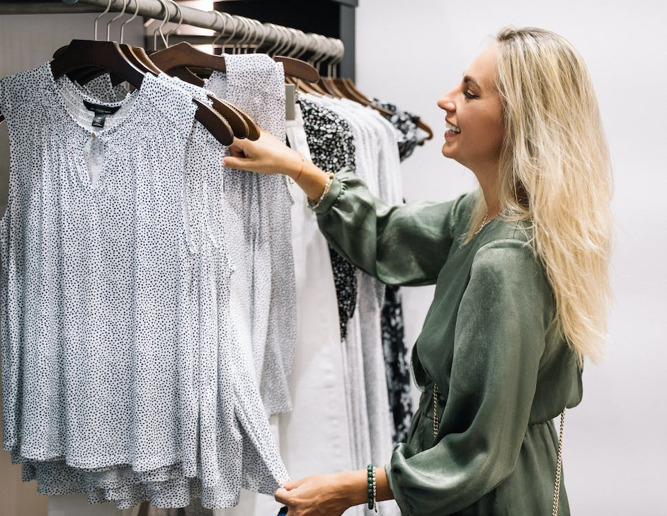 a middle-aged woman arranging for her minimalist wardrobe 