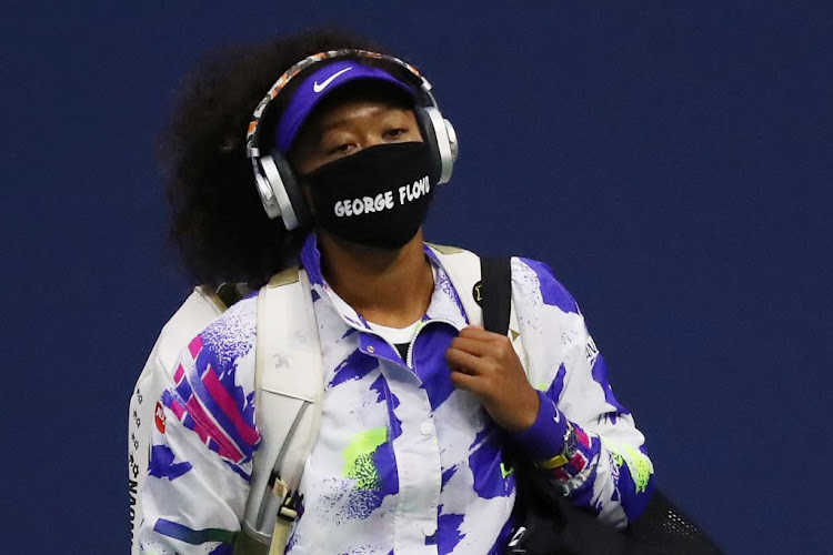 Naomi Osaka walks in wearing a mask with the name of George Floyd on it before her quarter-finals match against Shelby Rogers in the 2020 US Open. Osaka has been praised by golfer Michelle Wie West after withdrawing from the French Open following her decision not to attend post-match interviews.