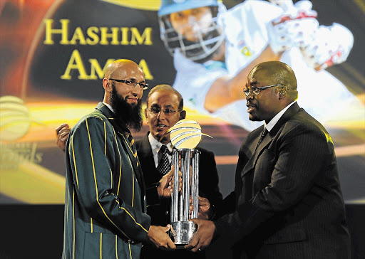 Hashim Amla receives the Cricketer of the Year award from Cricket SA chief executive Haroon Lorgat and president Chris Nenzani at the organisation's gala dinner and awards ceremony at the Sandton Convention Centre last night